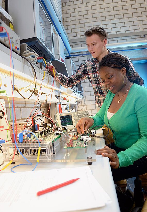 a male and a female student work and learn in a laboratory